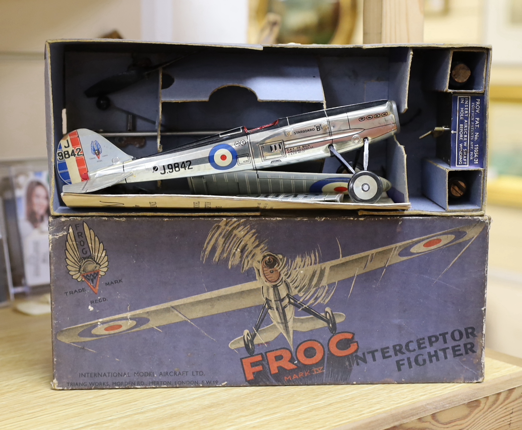 Four tinplate toys; a Frog Interceptor Fighter, a Bandai battery powered Cadillac Convertible (4025), a Crawford’s Biscuits Aeroplane and a clockwork Tri-ang Minic London Transport Double deck bus